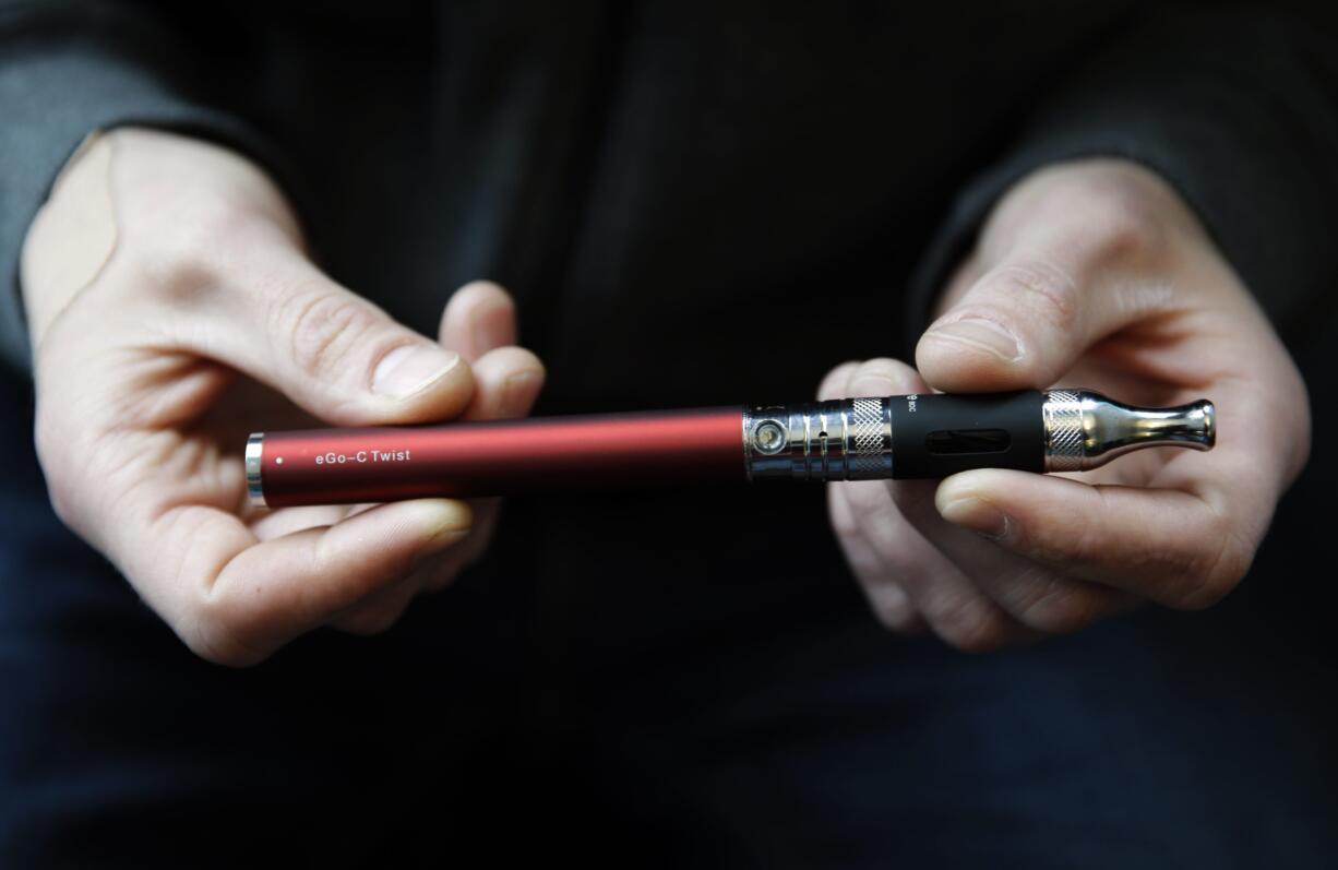 Eric Scheman holds an e-cigarette at Vape store in Chicago in September.