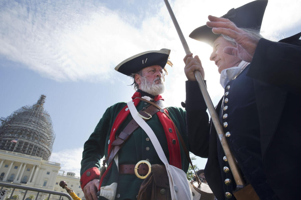 William Temple, left, playing the part of Button Gwinnett, and James Manship, playing George Washington, attend a Tea Party rally against the Iran deal expected to be attended by Republican presidential candidates Sen. Ted Cruz, R-Texas, and Donald Trump, on the West Lawn of the Capitol in Washington, Wednesday.