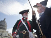 William Temple, left, playing the part of Button Gwinnett, and James Manship, playing George Washington, attend a Tea Party rally against the Iran deal expected to be attended by Republican presidential candidates Sen. Ted Cruz, R-Texas, and Donald Trump, on the West Lawn of the Capitol in Washington, Wednesday.