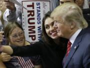 Republican presidential candidate Donald Trump takes a photo with a supporter after speaking at a campaign event in Dallas on Monday.