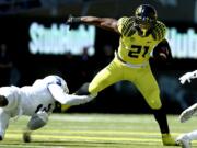 Oregon running back Royce Freeman (21) shakes the grasp of Georgia State's Tarris Batiste on Saturday, Sept. 19, 2015, in Eugene, Ore.