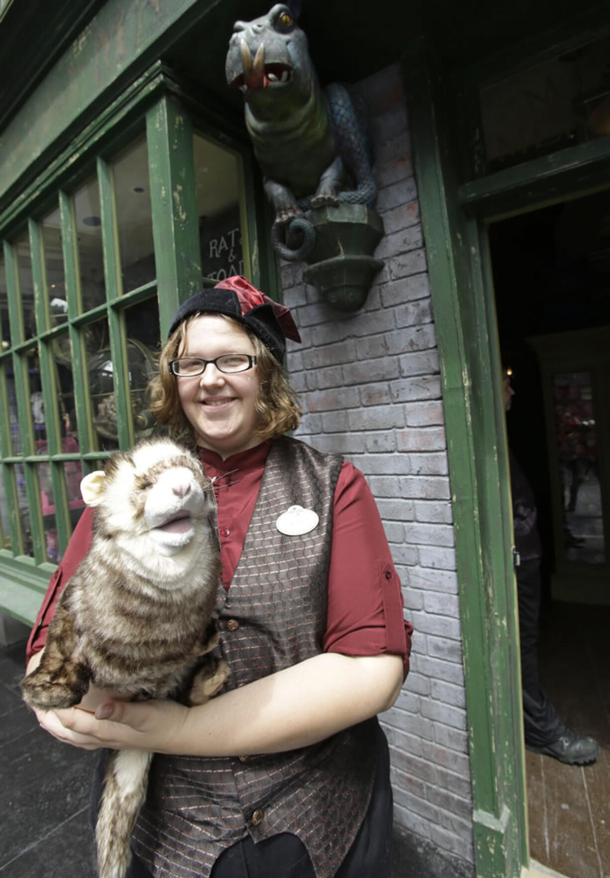 Allie Dillard shows off a ferret puppet that can be purchased at the Magical Menagerie store during a preview of Diagon Alley at the Wizarding World of Harry Potter at Universal Orlando, Thursday, June 19, 2014, in Orlando, Fla.