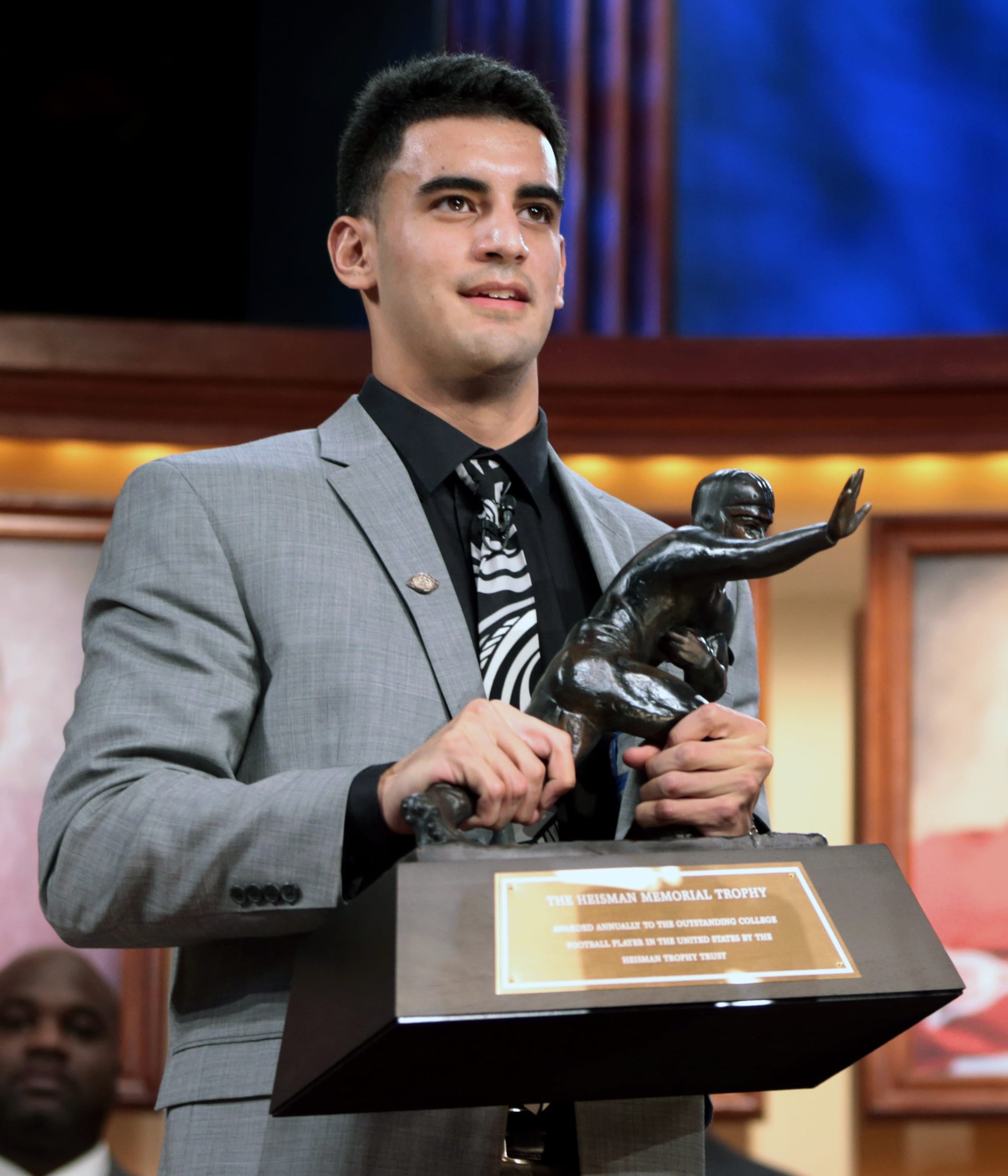 Oregon quarterback Marcus Mariota holds the Heisman Trophy after being named college football's best player during the Heisman Trophy presentation in New York on Saturday, Dec. 13, 2013.