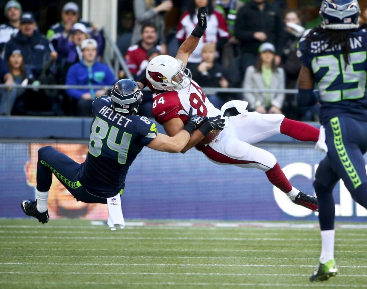 Seattle Seahawks tight end Cooper Helfet puts a big hit on Arizona's Rob Housler during a game Nov.