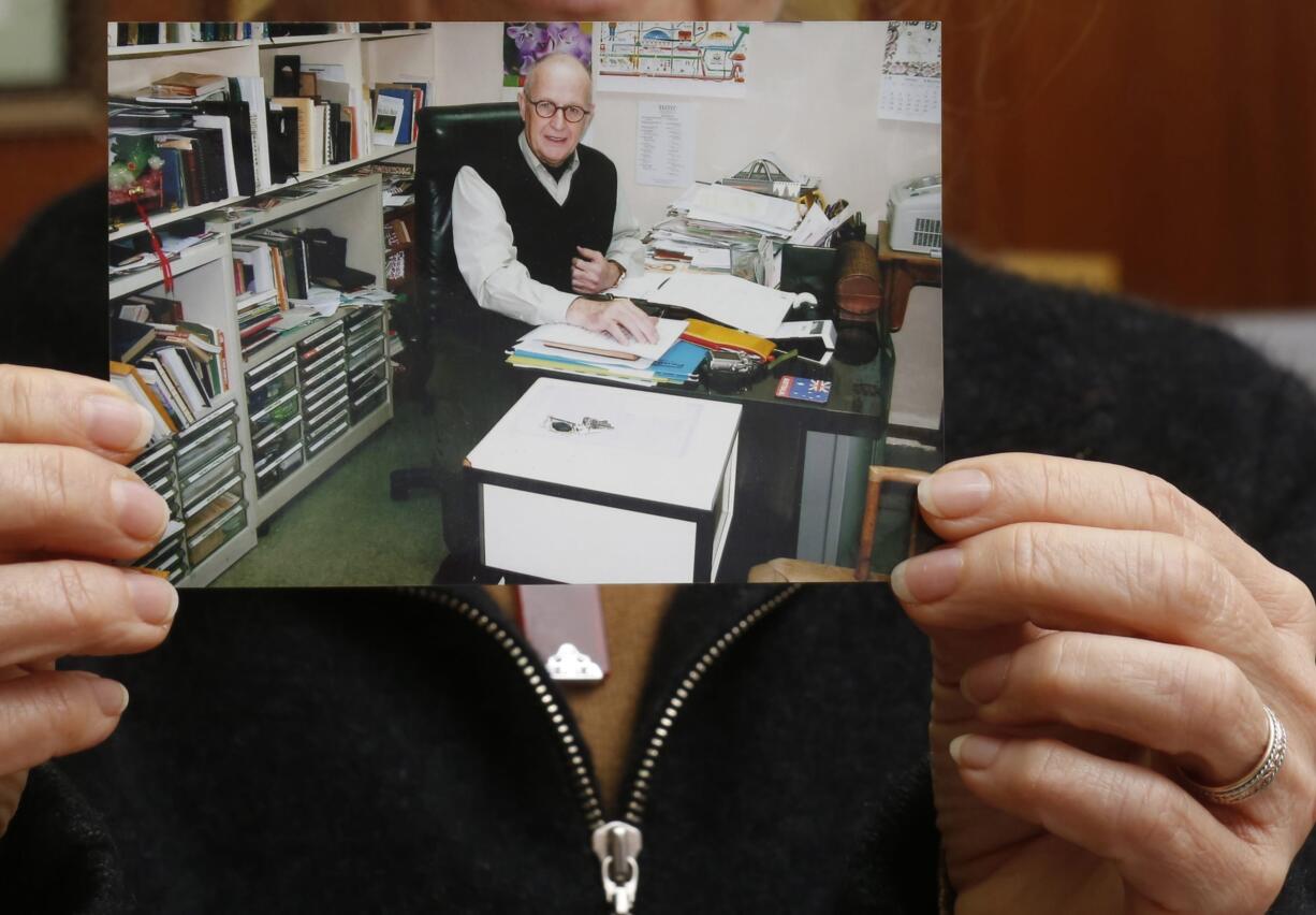 Karen Short, wife of Australian missionary John Short, holds a photo of her husband inside the Christian Book Room in Hong Kong Wednesday.