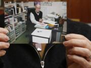 Karen Short, wife of Australian missionary John Short, holds a photo of her husband inside the Christian Book Room in Hong Kong Wednesday.