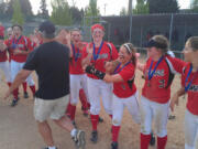 Camas players and coaches celebrate their district softball title