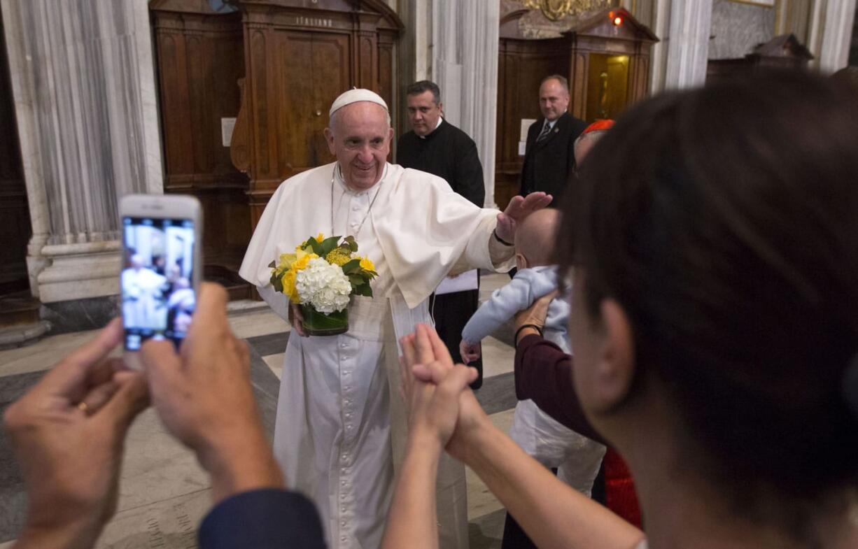 Pope Francis caresses a baby as he arrives to pray in Rome&#039;s St. Mary Major Basilica on Monday. Pope Francis returned to the Vatican Monday after a 10-day trip to Cuba and the United States.