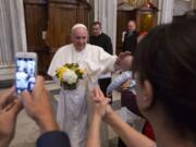 Pope Francis caresses a baby as he arrives to pray in Rome&#039;s St. Mary Major Basilica on Monday. Pope Francis returned to the Vatican Monday after a 10-day trip to Cuba and the United States.