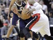 Portland Trail Blazers guard Damian Lillard, right, drives on Utah Jazz guard Trey Burke during the second half Friday. Lillard led Portland in scoring with 28 points as the Blazers won 102-94.