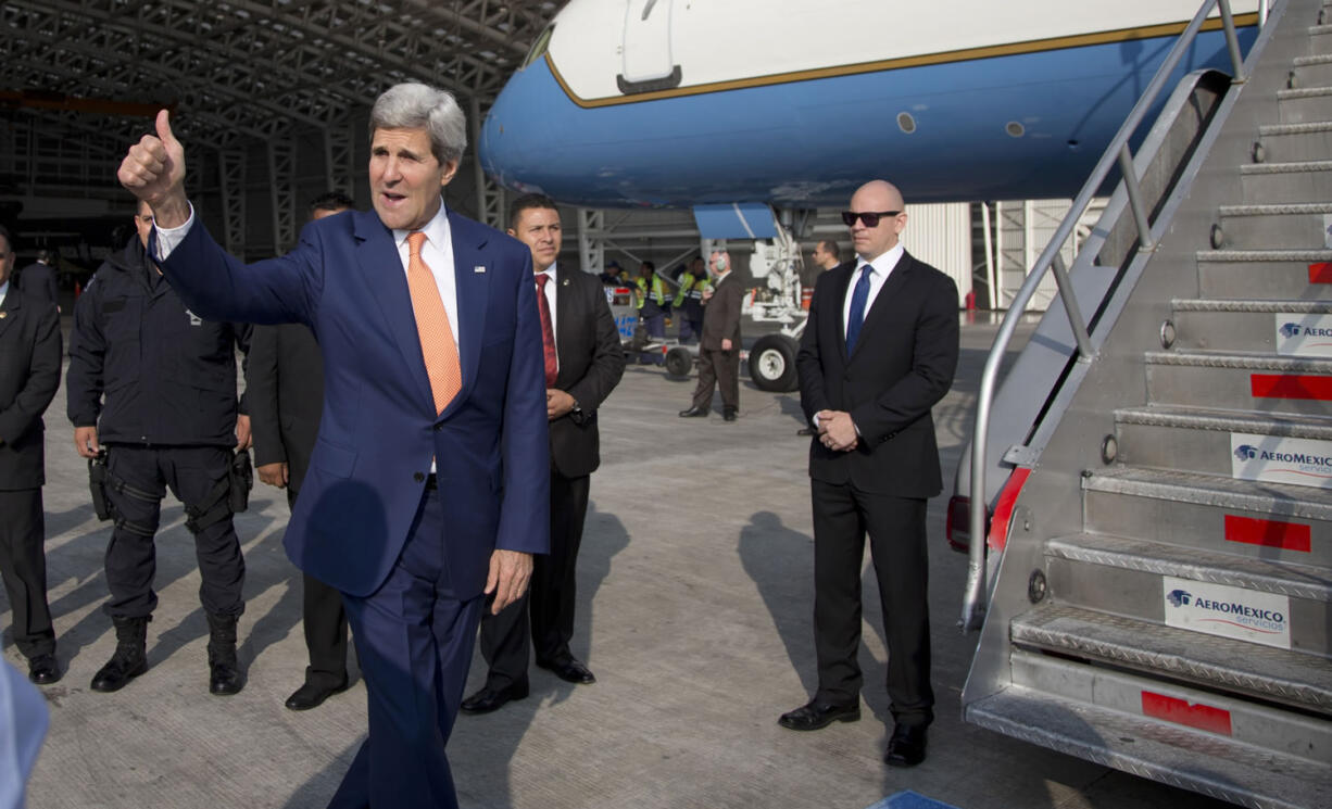 Secretary of State John Kerry gives the thumbs before boarding his plane in Benito Juarez International airport in Mexico City on Thursday, en route to Washington.