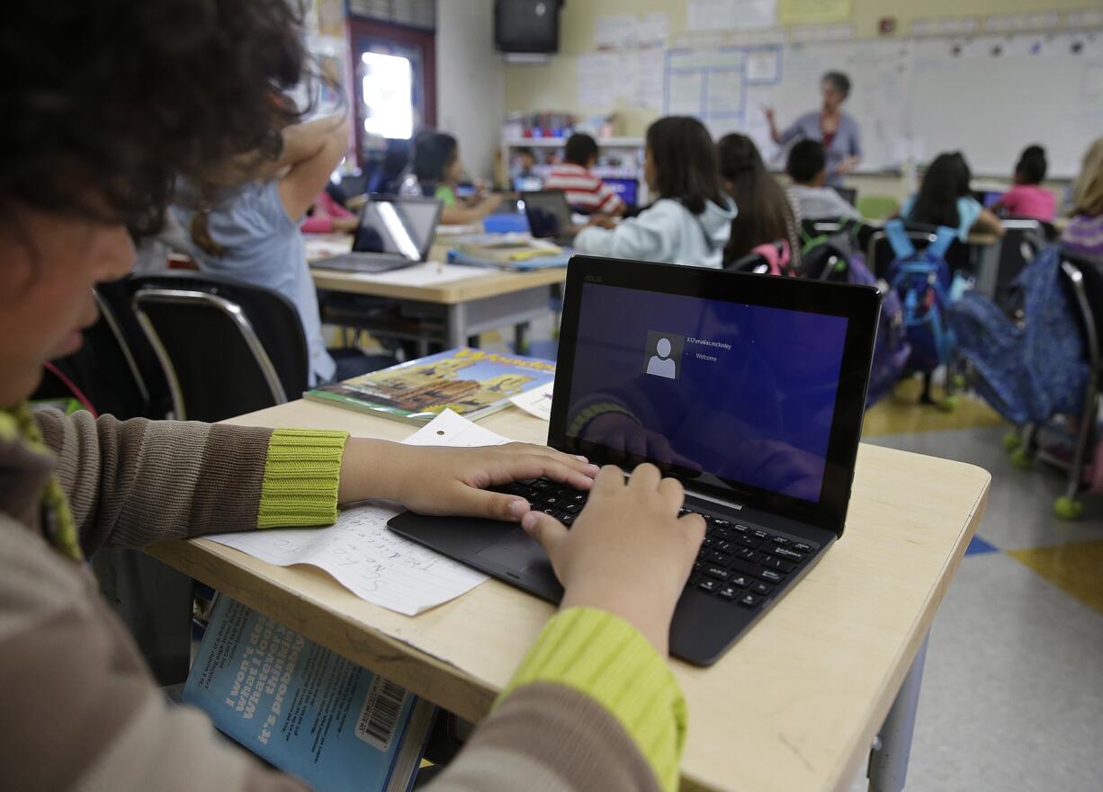 Photos by Eric Risberg/Associated Press
A fourth-grader logs onto an ASUS tablet to use Google docs to complete an exercise at Mira Vista School in Richmond, Calif.