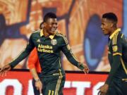 Portland Timbers' Dairon Asprilla (11), of Colombia, celebrates with teammate  Alvas Powell, of Jamaica, right, after scoring against New York City FC during an MLS soccer game at Yankee Stadium, Sunday, April 19, 2015, in New York.