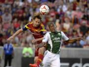 Real Salt Lake midfielder Ned Grabavoy, left, collides with Portland Timbers' Darlington Nagbe during an MLS soccer game Saturday, June 7, 2014, in Sandy, Utah.