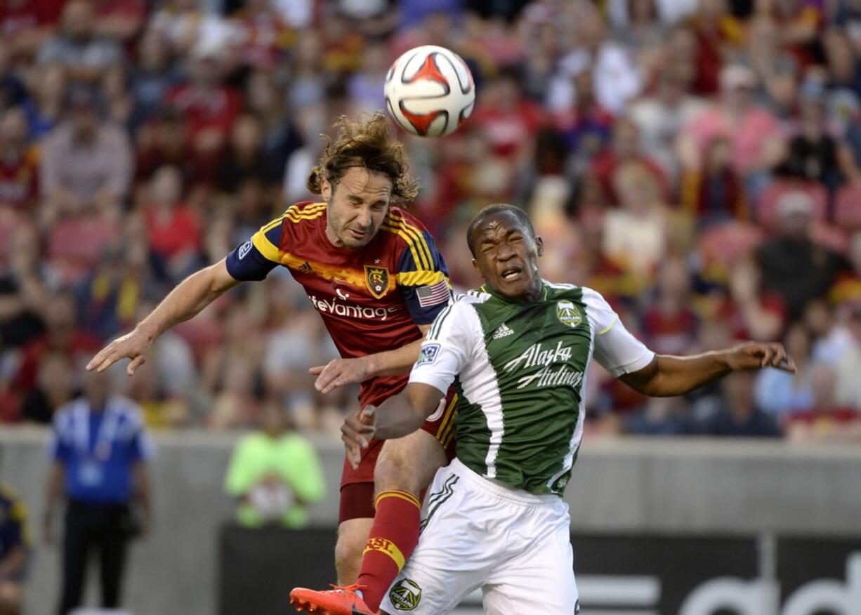 Real Salt Lake midfielder Ned Grabavoy, left, collides with Portland Timbers' Darlington Nagbe during an MLS soccer game Saturday, June 7, 2014, in Sandy, Utah.