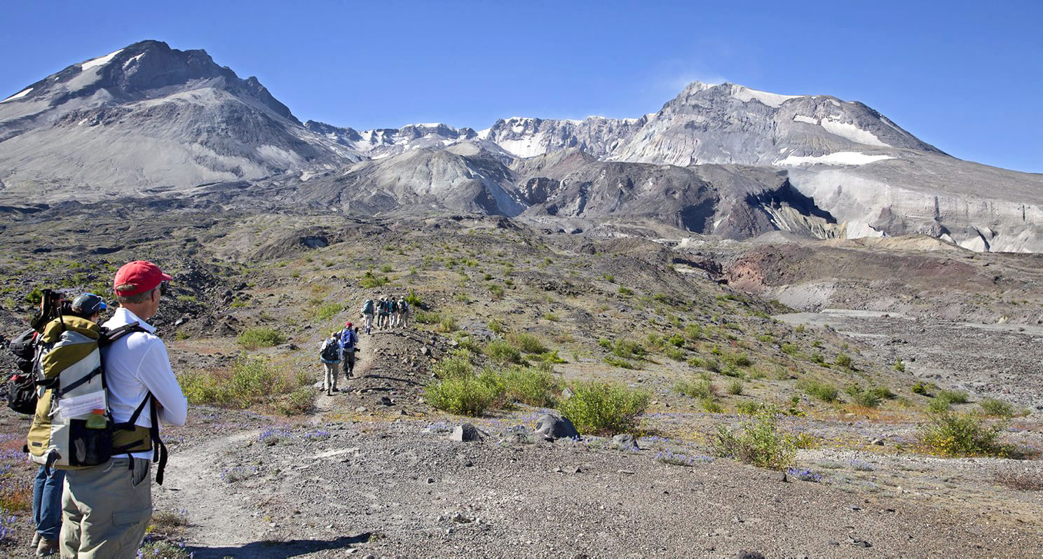 Hikers cross the flats on the north side of Mount St.