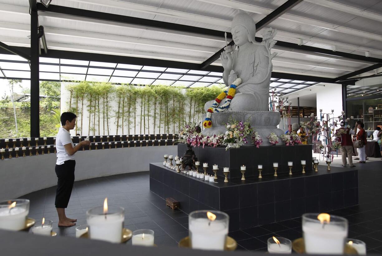 A Buddhist devotee offers prayers for passengers onboard the missing Malaysia Airlines Flight 370 at Kechara Forest Retreat in Bentong, Malaysia, on Sunday.