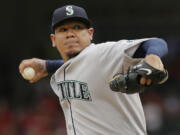 Felix Hernandez gave up two runs, struck out five and matched a season high with five walks against the Texas Rangers in Arlington, Texas, on Sunday, Sept. 20, 2015.