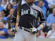 Seattle Mariners' Robinson Cano looks at his bat during the first inning of a spring training baseball game against the Chicago Cubs Thursday, March 20, 2014, in Mesa, Ariz.