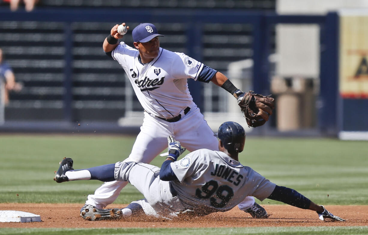 San Diego Padres shortstop Everth Cabrera throws to first to complete a double play as Seattle Mariners' James Jones  slides into second during the first inning Thursday in San Diego.