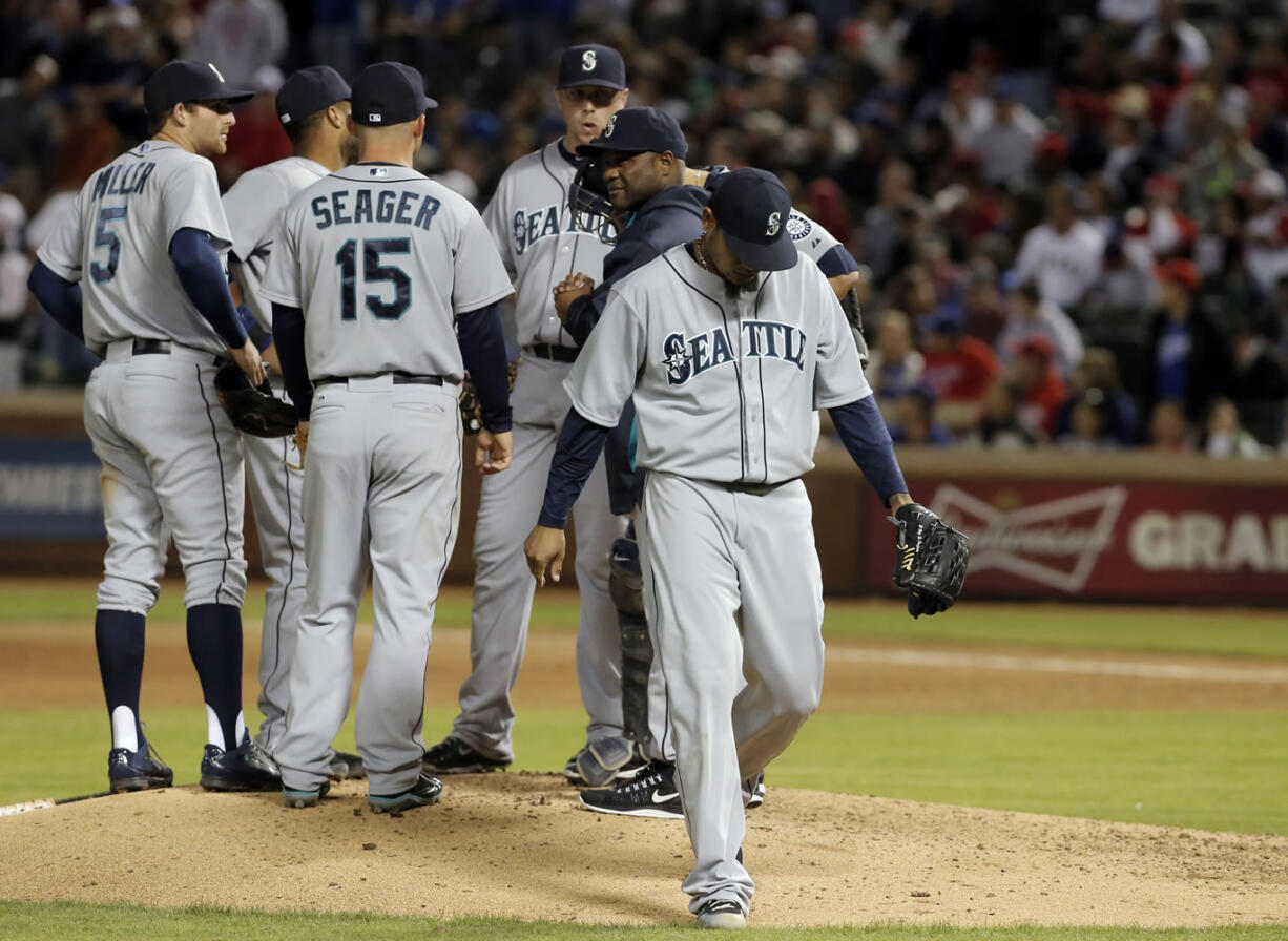 Seattle Mariners starting pitcher Felix Hernandez (34) walks to the dugout after being relieved during the eighth inning of a baseball game against the Texas Rangers, Wednesday, April 16, 2014, in Arlington, Texas. Texas won 3-2.