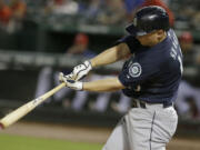 Seattle Mariners Kyle Seager (15) hits fly out during the fourth inning against the Texas Rangers Saturday, Sept. 6, 2014, in Arlington, Texas.