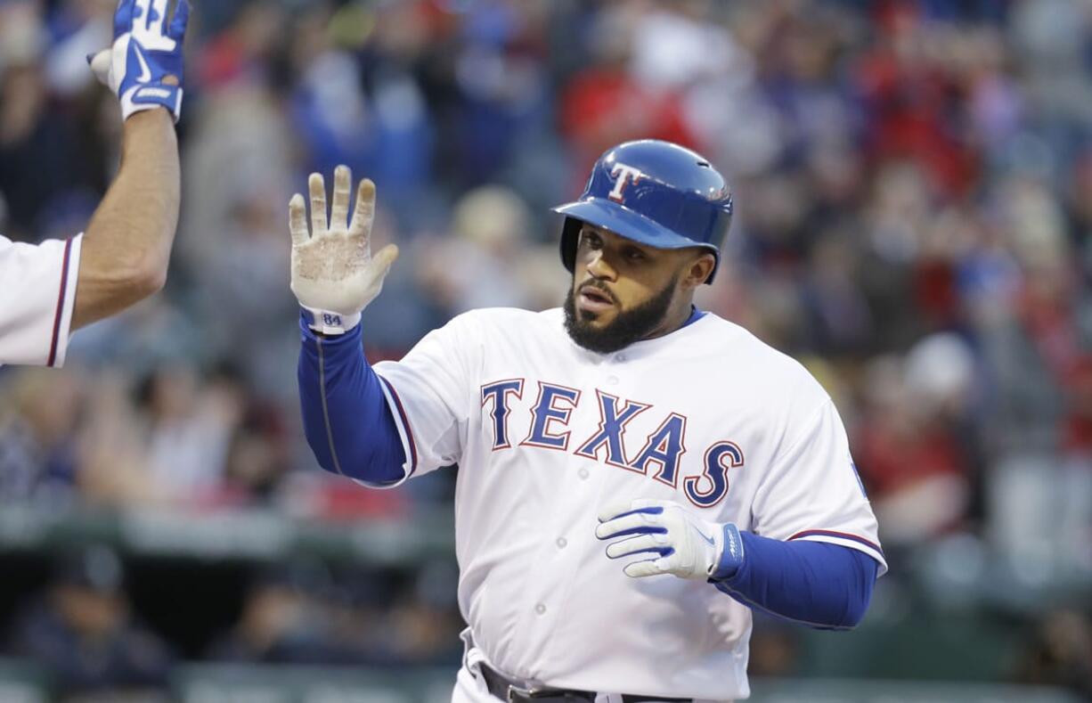 LM Otero/Associated Press
Texas Rangers' Prince Fielder is congratulated after his solo home run during the second inning.