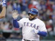 LM Otero/Associated Press
Texas Rangers' Prince Fielder is congratulated after his solo home run during the second inning.