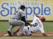 Seattle Mariners second baseman Robinson Cano (22) is unable to hold onto the throw from home as Texas Rangers' Adam Rosales (9) steals second during the sixth inning of a baseball game, Sunday, Sept. 7, 2014, in Arlington, Texas. Rosales would take third on the play.