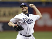 Tampa Bay Rays starting pitcher Erik Bedard delivers to the Seattle Mariners during the first inning of a baseball game Friday, June 6, 2014, in St. Petersburg, Fla.