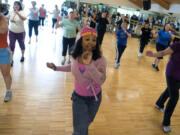 Fitness instructor Rachelle Wish, foreground center, leads a Zumba class at the Marshall Community Center.