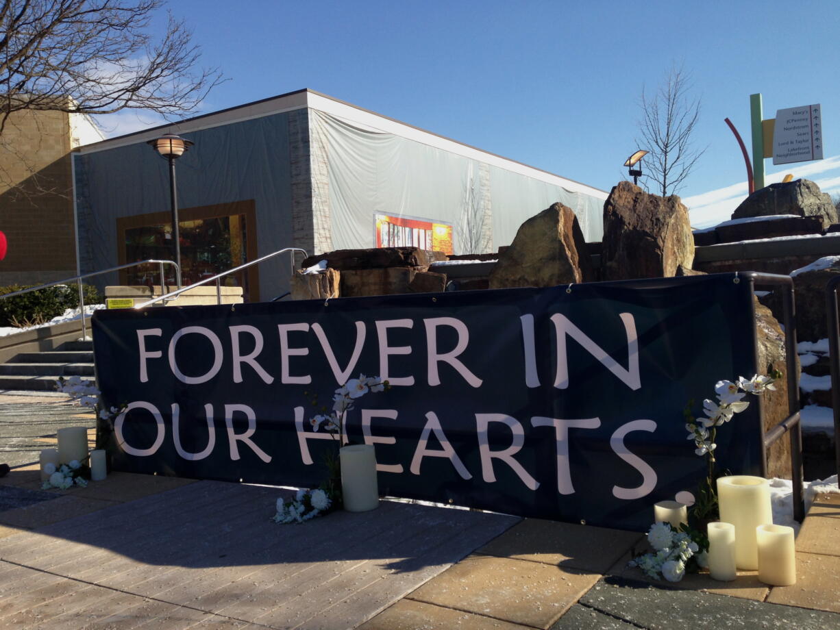 A makeshift memorial sits outside the Mall of Columbia, Md., on Monday after a weekend shooting that left three people, including the gunman, dead.