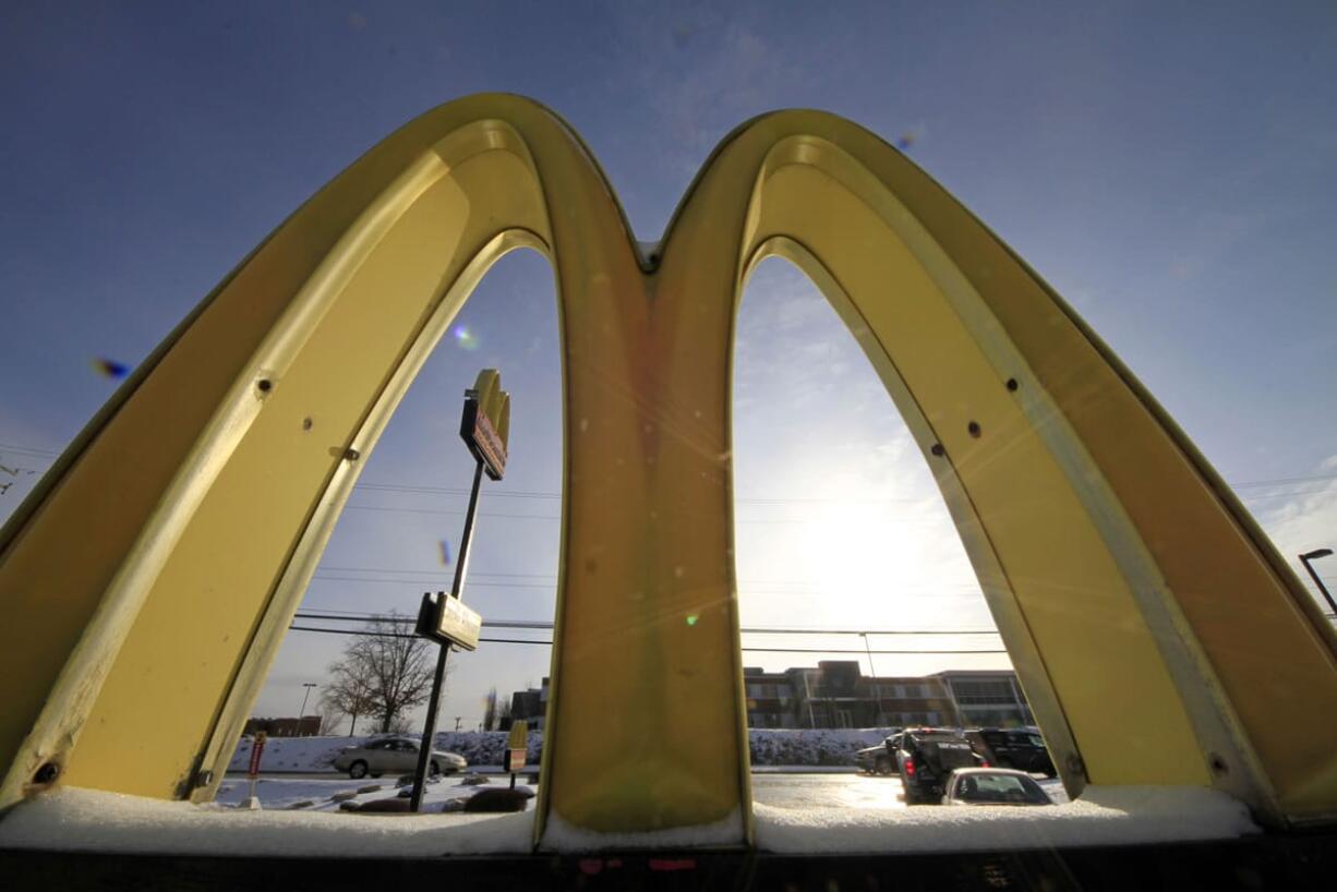 Cars drive past the McDonald's Golden Arches logo at a McDonald's restaurant in Robinson Township, Pa.  (AP Photo/Gene J.