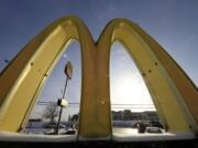 Cars drive past the McDonald's Golden Arches logo at a McDonald's restaurant in Robinson Township, Pa.  (AP Photo/Gene J.