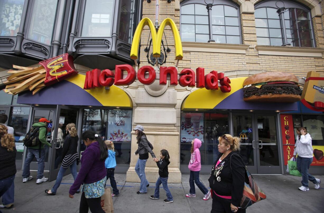 People make their way past the McDonald's restaurant at Fisherman's Wharf in San Francisco.