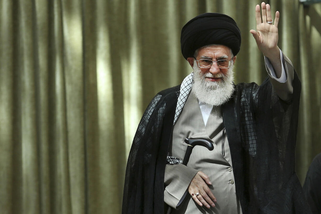 Iran's Supreme Leader Ayatollah Ali Khamenei waves to the crowd while attending a ceremony marking 25th death anniversary of the late revolutionary founder Ayatollah Khomeini at his shrine just outside Tehran, Iran, on Wednesday.