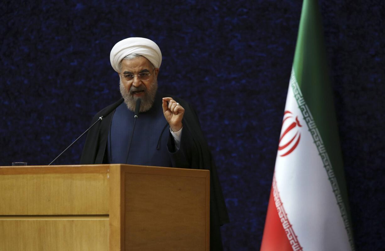 Iranian President Hassan Rouhani delivers his speech in a ceremony marking National Nuclear Technology Day, in Tehran, Iran, Thursday, April 9, 2015. Rouhani warned that Tehran will not sign on to a final nuclear deal with world powers unless it is predicated on the lifting of economic sanctions imposed on Iran over the controversial nuclear program.