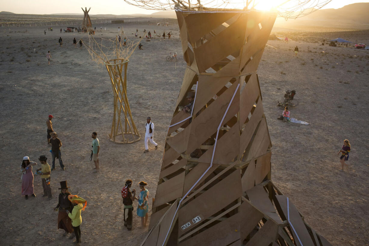 People, mostly Israelis, walk in the playa during Israel's first Midburn festival, modeled after the popular Burning Man festival held annually in the Black Rock Desert of Nevada, in the desert near the Israeli kibbutz of Sde Boker.