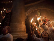 Christian pilgrims hold candles at the church of the Holy Sepulcher, traditionally believed to be the burial site of Jesus Christ, on Saturday during the ceremony of the Holy Fire in Jerusalem's Old City.