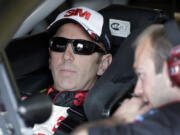 Greg Biffle, left, talks to a crew member before a NASCAR Sprint Cup series auto race practice at Darlington Speedway in Darlington, S.C., Friday.