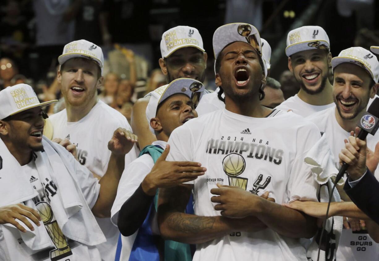 NBA Finals Most Valuable Player Kawhi Leonard, center foreground, leads the celebration after the San Antonio Spurs wrapped up the league championship with a 104-87 victory over the Miami Heat in Game 5 on Sunday.