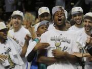 NBA Finals Most Valuable Player Kawhi Leonard, center foreground, leads the celebration after the San Antonio Spurs wrapped up the league championship with a 104-87 victory over the Miami Heat in Game 5 on Sunday.