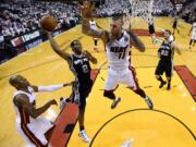 San Antonio Spurs forward Kawhi Leonard (2) goes to the basket as Miami Heat forward Chris Andersen (11) defends in the first half in Game 4 of the NBA basketball finals in Miami, Thursday, June 12, 2014. The Spurs won 107-86. (AP Photo/Larry W.