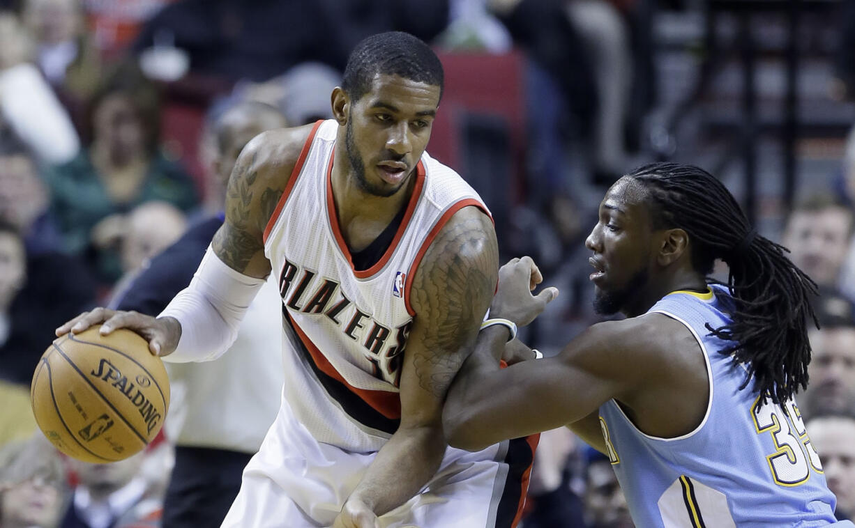 Portland Trail Blazers forward LaMarcus Aldridge, left, works the ball against Denver Nuggets forward Kenneth Faried during the first half of an NBA basketball game in Portland, Ore., Thursday, Jan. 23, 2014.