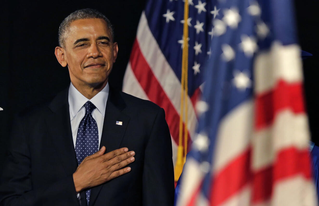 President Obama stands for the National Anthem during the graduation ceremony for Worcester Technical High School on Wednesday in Worcester, Mass.