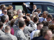 President Barack Obama shakes hands with the crowd on the tarmac upon his arrival on Air Force One on Monday at Des Moines International Airport in Des Moines, Iowa.