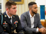 President Barack Obama meets with Oregon National Guardsman Alek Skarlatos, left,  Anthony Sadler, right, and Air Force Airman 1st Class Spencer Stone in the Oval Office of the White House in Washington on Thursday to honor them for heroically subduing a gunman on a passenger train in Paris last month.