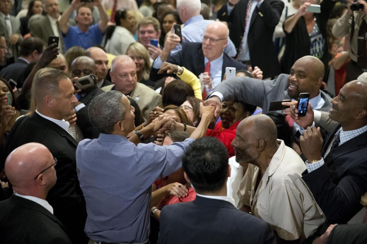 President Barack Obama greets members of the crowd after speaking at the Greater Boston Labor Council Labor Day Breakfast on Monday in Boston. Obama will sign an executive order requiring federal contractors to offer their employees up to seven days of paid sick leave per year.