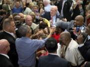 President Barack Obama greets members of the crowd after speaking at the Greater Boston Labor Council Labor Day Breakfast on Monday in Boston. Obama will sign an executive order requiring federal contractors to offer their employees up to seven days of paid sick leave per year.