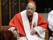 Retiring Cardinal Francis George listens Nov. 17, 2014, at Holy Name Cathedral in Chicago during Bishop Blase Cupich's Rite of Reception service. The Chicago Archdiocese announced Friday that George died after a long bout with cancer. He was 78.